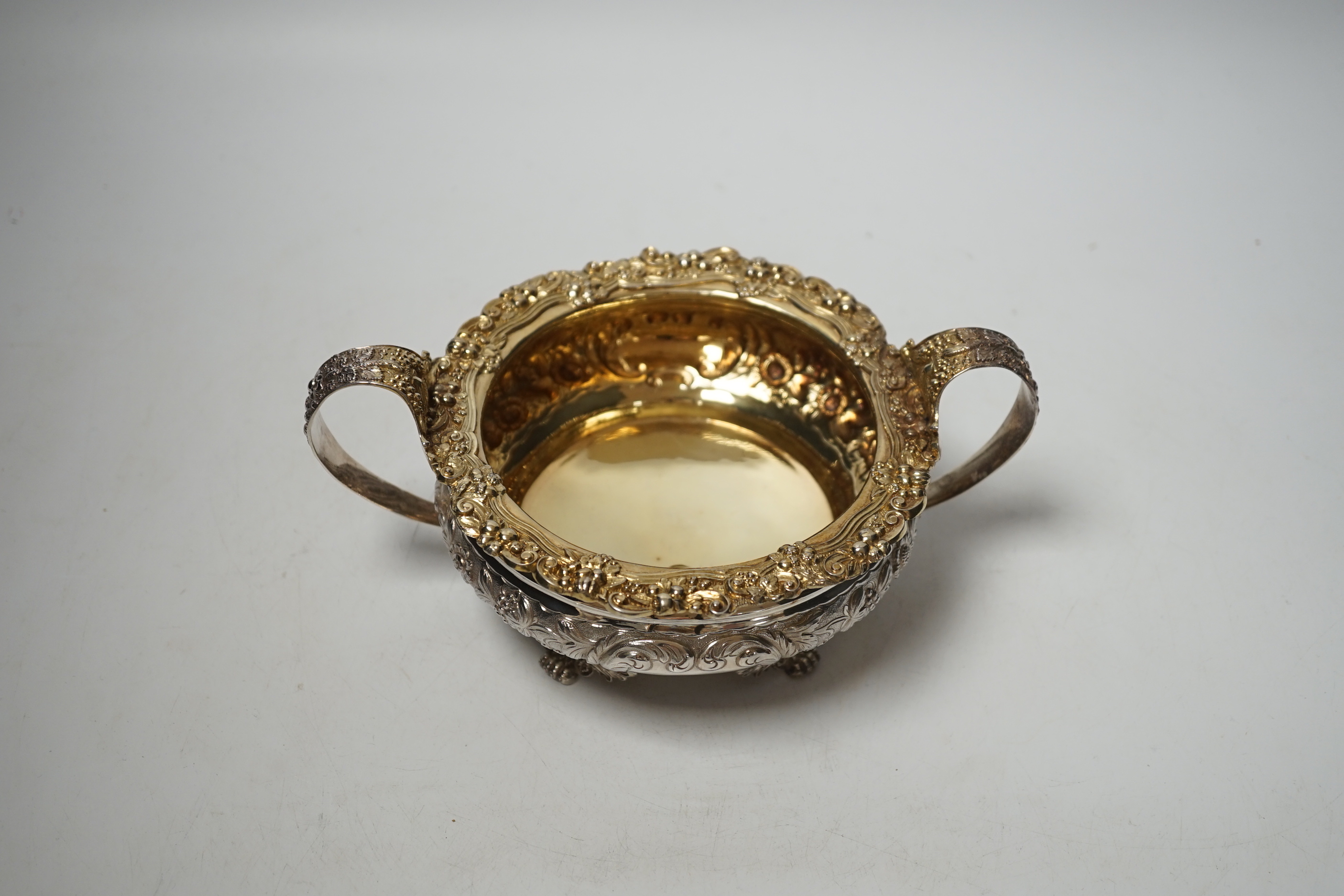 A George IV embossed silver two handled sugar bowl, Thomas James, London, 1822, diameter 14.7cm, 12.7oz.